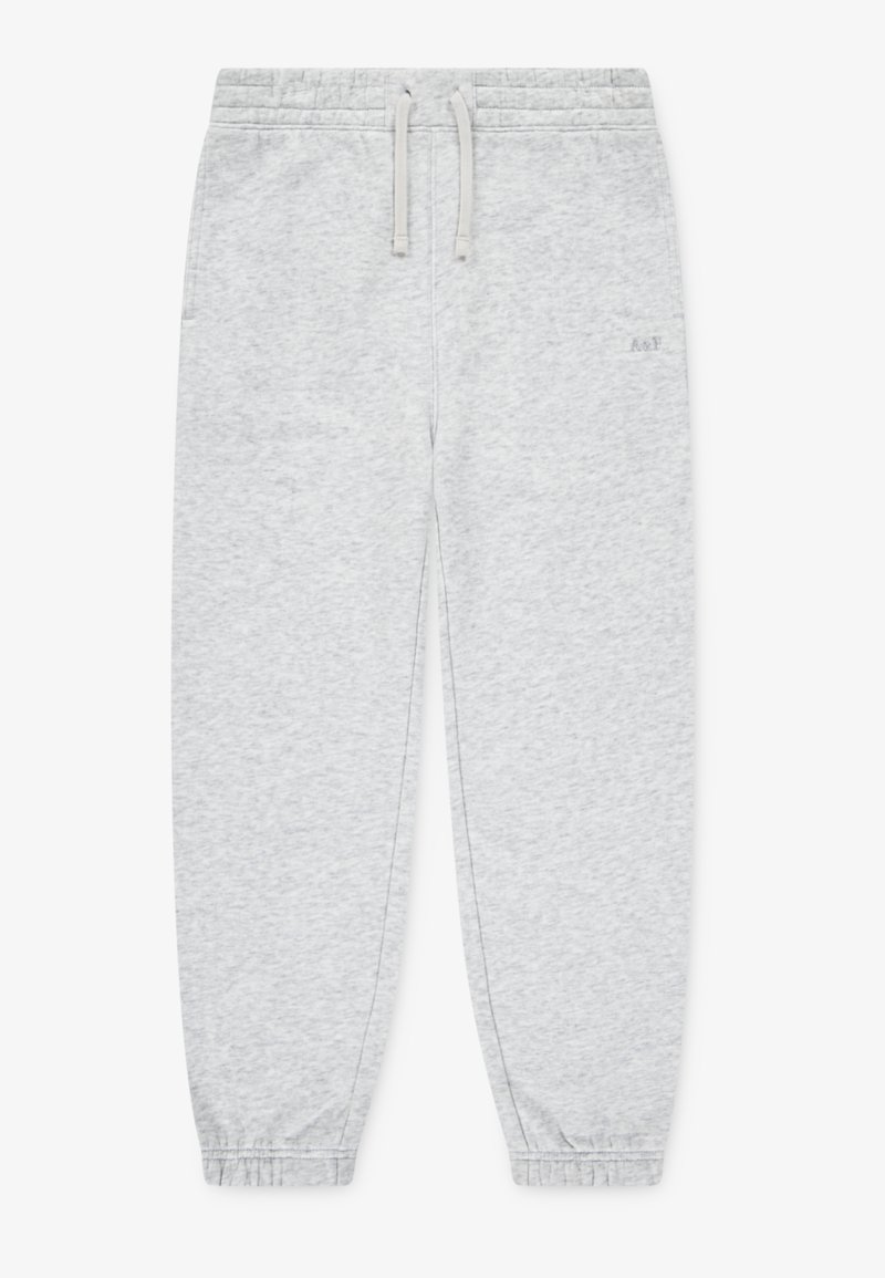 Lys grå joggebukser laget av mykt stoff, med snor i livet, elastiske mansjetter og en liten logo foran.