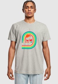Pilkas medvilninis marškinėliai su daugiakrypčiu saulės ir palmų grafiniu atvaizdu, kuriame yra užrašas „ROLLER SKATER CLUB VENICE BEACH“. Trumpomis rankovėmis.