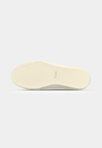 Sole of a sneaker, light cream color with textured surface and a rounded shape. Features subtle branding embossed near the heel.
