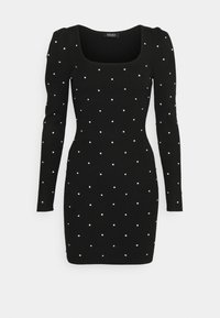 Robe noire moulante à manches longues avec un décolleté carré, ornée de petites perles blanches nacrées réparties uniformément sur le tissu.