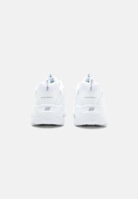 White athletic shoes with a chunky sole, mesh upper, and reinforced heel, featuring small logo accents and pull tabs for easy wearing.