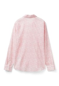 Dlouhý rukáv tričko z světle růžové látky s květinovým vzorem. Obsahuje límec a zapínání na knoflíky na manžetách. Zadní pohled ukazuje celkový design.