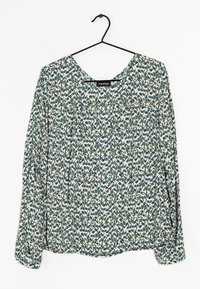 Blouse à manches longues avec un col rond, fabriquée en tissu léger avec un motif géométrique multicolore dans des tons de vert, rose et gris.