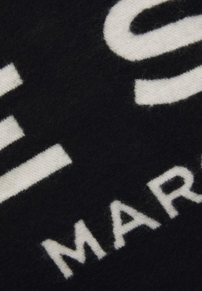 Black wool fabric with large white lettering. The texture is soft, featuring a fuzzy surface. Notable accents include bold text design.