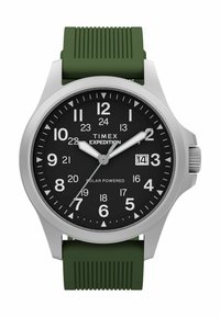 Zegarek Timex Expedition z czarną tarczą, białymi cyframi, wyświetlaczem daty na trzeciej godzinie, srebrną kopertą i zielonym silikonowym paskiem o fakturze.