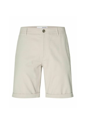 Beige kokvilnas šorti taisnā griezumā, ar salocītu apmale, priekšējo pogu aizdari un divām sānu kabatām. Minimālistisks dizains.