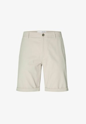 Bež pamuk kratke hlače ravnog kroja, s preklopom na rubovima, prednjim dugmetom za zatvaranje i dva bočna džepa. Minimalistički dizajn.