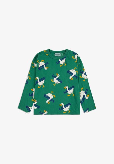 Zelena košulja dugih rukava s ponavljajućim uzorkom crtanih pataka s narančastim kljunovima i nogama, te plavim natpisom "LA OCA."
