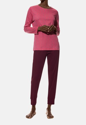 Long-sleeve pink shirt with floral pattern paired with maroon pants, crafted from soft fabric, featuring a relaxed fit and elastic cuffs.
