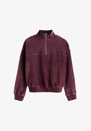 Burgundi kordbársony pulóver magas nyakkal, félcipzárral, bordázott textúrával és elasztikus mandzsettákkal és aljjal.