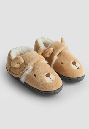 Brune plyssede tøfler med bjørne-design, der har blødt pelsfor, ører og en sort sål. Velcro-rem for en sikker pasform.