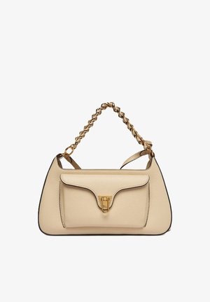 Beige leather handbag with front pocket and gold clasp, featuring a short handle made of interwoven gold chain and leather.