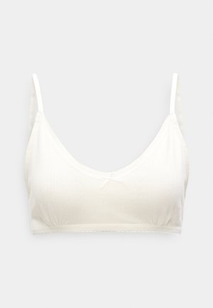 Απαλό κρεμ σουτιέν με V ντεκολτέ, λεπτές ράντες, υφασμάτινη υφή και μικρό φιόγκο στο κέντρο. Αόρατα άκρα και απλός σχεδιασμός.