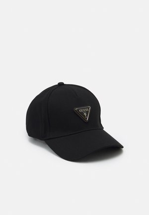 Black baseball cap with curved visor and a triangular Guess logo patch on the front center.