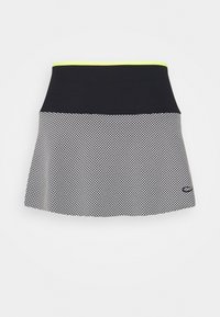 Skort en blanco y negro con una sección inferior texturizada y con patrón, cintura negra lisa y un acento verde neón en el borde superior.