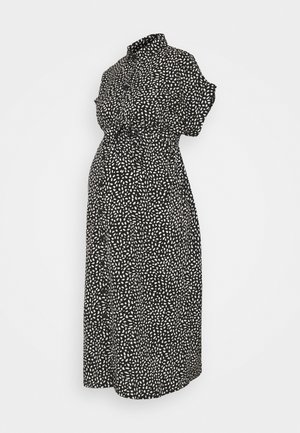 Robe midi noire à manches courtes, boutonnée sur le devant, col et motif de points blancs irréguliers.