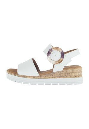 White leather wedge sandals with open toe, adjustable ankle strap, and a circular braided accent in beige, purple, and cream shades.