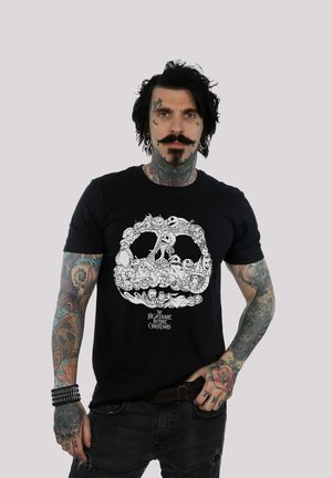 Black cotton t-shirt featuring a white graphic design of a skull filled with characters from "The Nightmare Before Christmas."