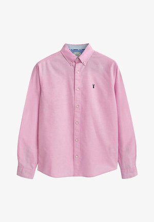 Vaaleanpunainen napitettava paita, jossa on pitkät hihat, kaulus ja pieni musta brodeerattu logo rinnassa. Valmistettu sileästä kankaasta.