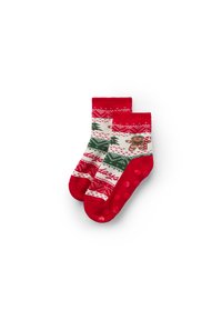 Red and cream socks featuring a festive print of gingerbread and Christmas trees, with red grip dots on the sole for added traction.