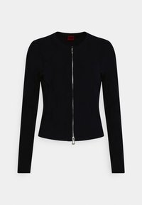 Laivastonsininen vetoketjullinen takki pyöreällä kaula-aukolla, pitkät hihat ja istuva malli. Siinä on vastavärinen hopeanvärinen vetoketju ja sileä pinta.