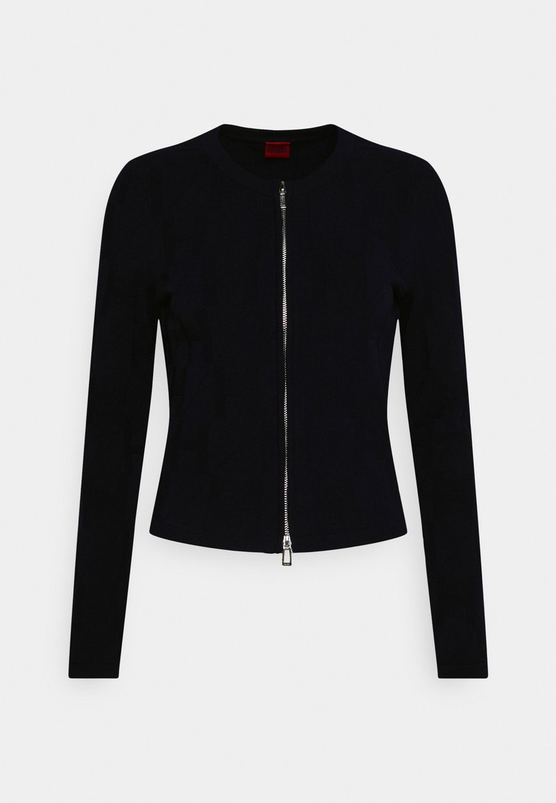 Laivastonsininen vetoketjullinen takki pyöreällä kaula-aukolla, pitkät hihat ja istuva malli. Siinä on vastavärinen hopeanvärinen vetoketju ja sileä pinta.