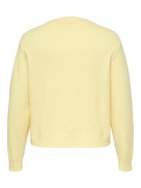 Gul genser laget av mykt, teksturert materiale. Har rund hals, lange ermer og en ledig passform med ribbestrikkede mansjetter og kant.