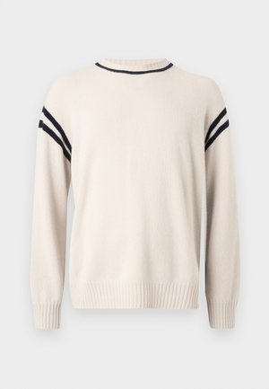 Maglione beige chiaro realizzato in materiale morbido, con scollo a girocollo, polsini a coste e strisce nere lungo le spalle come dettaglio.