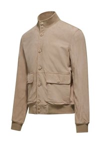 Giacca in suede beige con colletto alto, bottoni frontali, due tasche laterali e polsini a coste. Texture morbida con un design minimale.