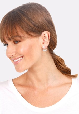 Silver earrings with a round top and a curved line of four small spheres below. Lightweight design with polished metallic finish.