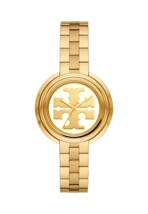 Reloj de pulsera en tono dorado con brazalete enlazado, esfera circular y gran emblema estilizado en el centro que reemplaza los marcadores tradicionales de horas.