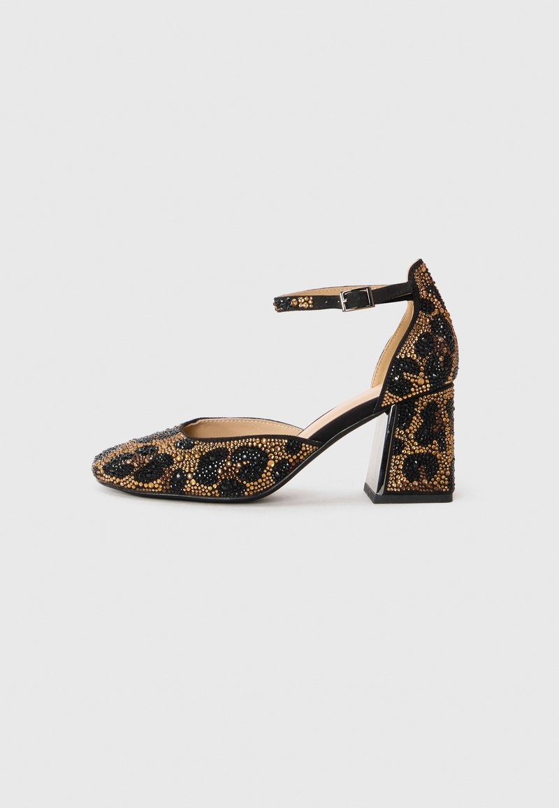 Black and gold beaded high-heeled shoe with an ankle strap, pointed toe, and block heel featuring a leopard print pattern.
