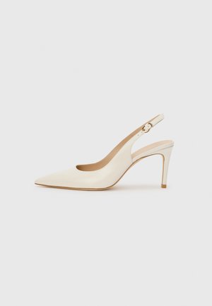 White high heel slingback shoe with a pointed toe, smooth leather material, minimal design, and a thin heel with a gold accent.