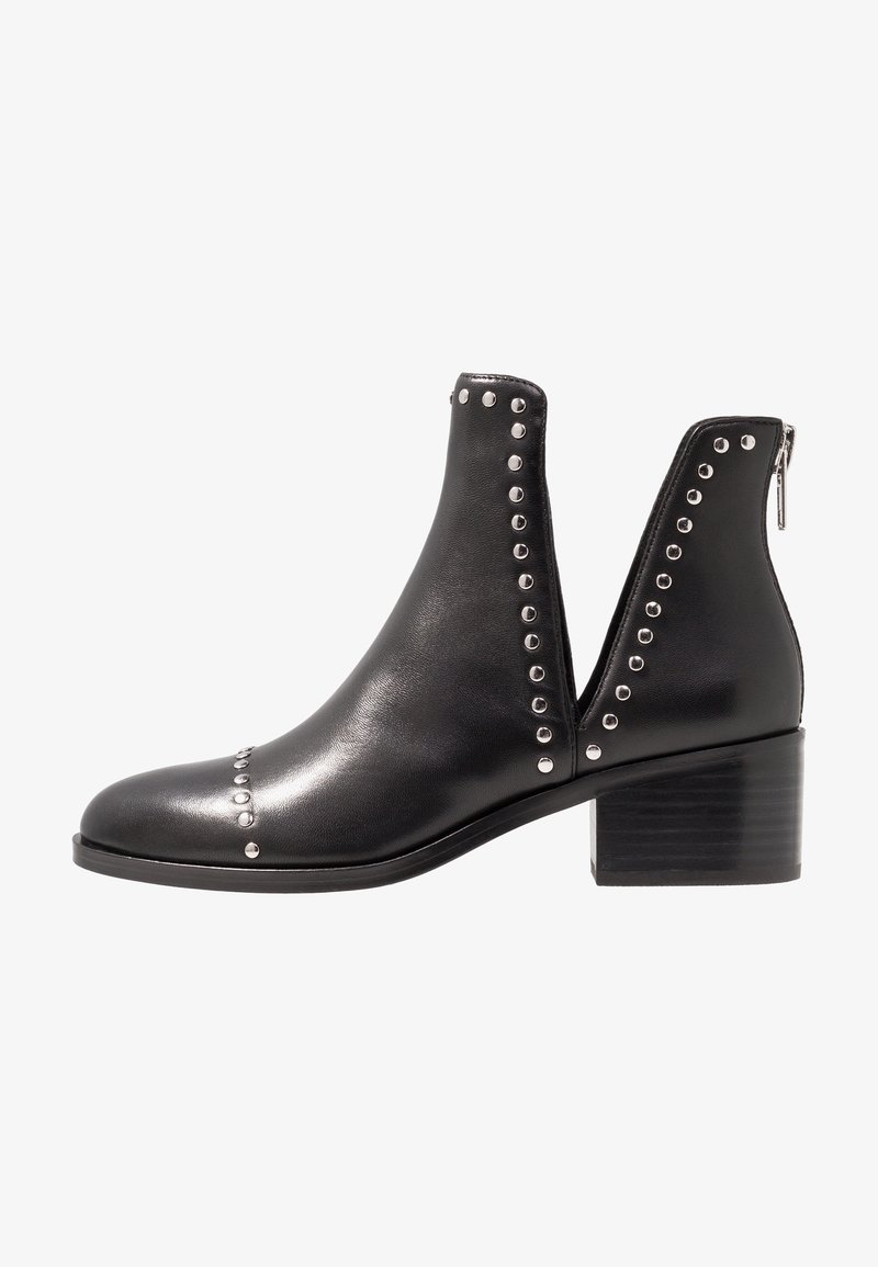 Black leather ankle boots with metal stud detailing, cut-out sides, and a chunky heel. Features a zipper at the back for easy wear.
