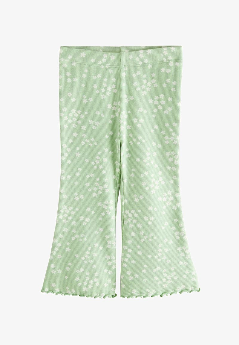 Pantaloni a coste verde chiaro con piccolo motivo floreale bianco e orli arricciati, modello a gamba larga e svasata.
