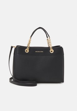 Bolso de piel negra de Michael Kors con acentos de cadena dorada, asas superiores y una correa de hombro desmontable. Textura suave, diseño estructurado.