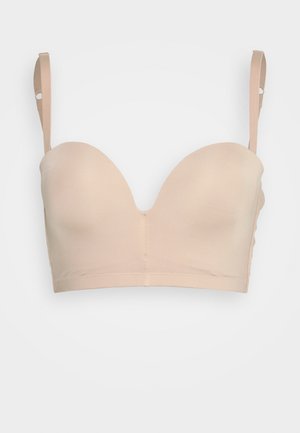 Μπέζ, μαλακό bralette με λείες, χωρίς ραφές cups, ρυθμιζόμενους ιμάντες και φαρδιά ζώνη; φτιαγμένο από μαλακό, ελαστικό ύφασμα.