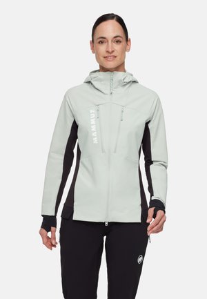 Ljusgrå softshell-jacka med svarta detaljer. Har en dragkedja fram, justerbar huva och logotypdetalj. Tights passform vid ärmarna med tumhål.