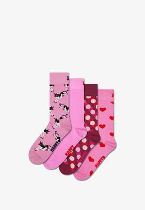Four pairs of crew socks: pink with black and white cows, solid pink, maroon with polka dots, and pink with red hearts. Red "HAPPY" text.
