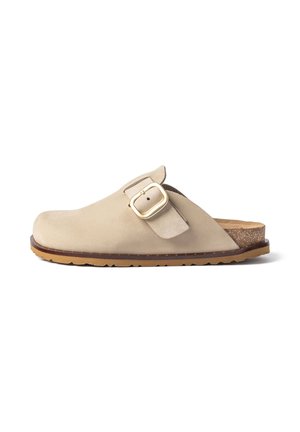 Beige slip-on clog with a large gold buckle on the side, cork footbed, and tan rubber sole with ridged tread.