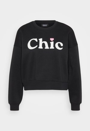 Čierny skrátený sveter vyrobený z bavlny, s veľkým bielym textom "Chic" a ružovým srdiečkom. S rebrovanými manžetami a okrúhlym výstrihom.