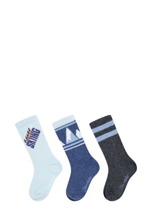 Three pairs of socks: light blue with "SKIING" text, navy with mountain pattern, and black with blue stripes. Ribbed texture, mid-calf length.