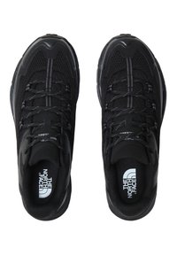 Black athletic shoes featuring a mesh upper, reinforced toe, and textured outsole. Laces and logo are visible on the insoles.