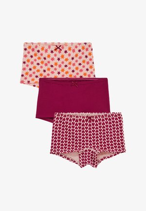 Trois boxers pour filles : un uni rose foncé, un rose avec des cœurs rose foncé, et un rose clair avec des étoiles orange et rose foncé, tous avec de petits nœuds.