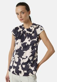 Navy and cream floral print blouse, short puff sleeve, gathered neckline, soft fabric, with abstract floral patterns and smooth texture.