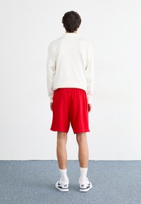 Nike Sportswear Pantaloni de trening - university red/white