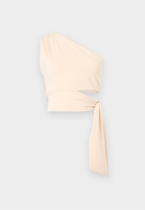 Cream-colored one-shoulder crop top with a long side tie detail and slight ruching on the shoulder.