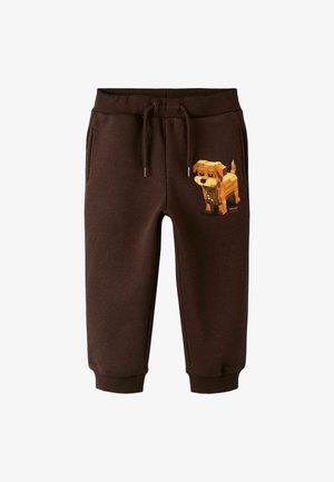 Brune fleece joggers med elastisk talje, med et pixeleret hundegrafik på venstre ben og med manchetter ved anklerne.