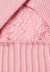 Pink knit fabric featuring a textured upper section and smooth ribbed lower section, with visible stitching details and a soft finish.