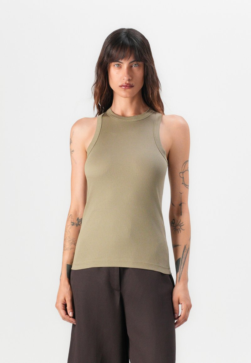 Olive green sleeveless ribbed tank top with a high neckline and fitted shape, made from soft jersey fabric. Plain design, minimal details.